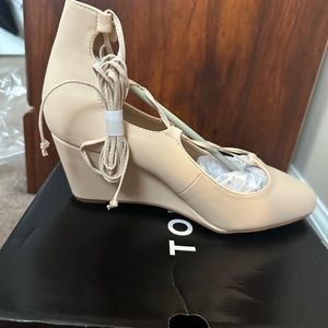 Torrid size 9, wide blush/nude/cream-color wedge/heels with lace up accents